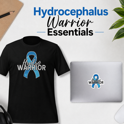 A black T-shirt and a silver laptop both display a blue awareness ribbon with the words 'Hydrocephalus WARRIOR' on them, arranged on a light surface with a pencil, plant leaves, and headphones nearby. Large text at the top reads 'Hydrocephalus Warrior Essentials'.